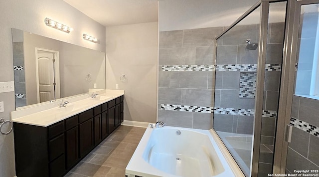 bathroom featuring a garden tub, tile patterned flooring, double vanity, tiled shower, and a sink