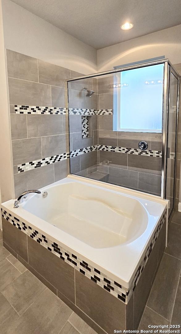 bathroom with recessed lighting, tile patterned floors, a shower stall, and a bath
