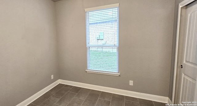 unfurnished room featuring baseboards