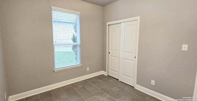 spare room featuring baseboards and a wealth of natural light