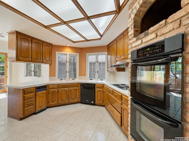 9 Chester Downs, San Antonio, TX 78257 - kitchen with brown cabinetry, a sink, black appliances, and a wealth of natural light