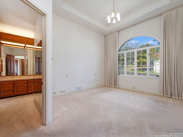 9 Chester Downs, San Antonio, TX 78257 - interior space with light colored carpet, a notable chandelier, a raised ceiling, visible vents, and ornamental molding