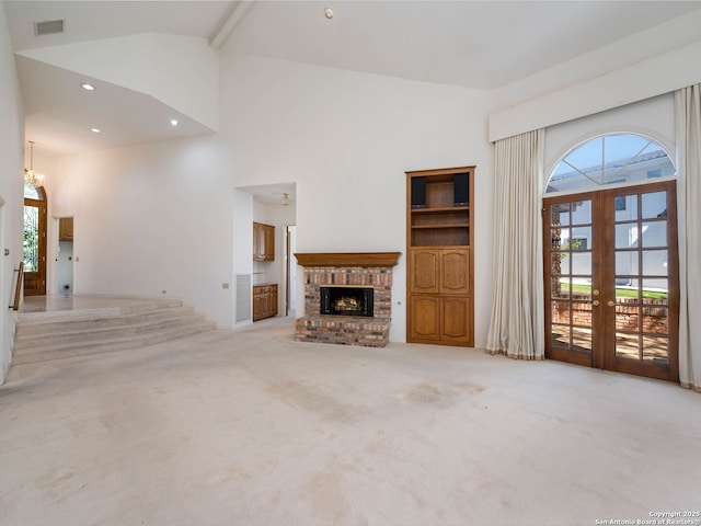 9 Chester Downs, San Antonio, TX 78257 - unfurnished living room featuring a notable chandelier, a fireplace, high vaulted ceiling, french doors, and carpet