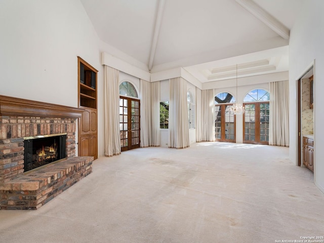 9 Chester Downs, San Antonio, TX 78257 - unfurnished living room with a healthy amount of sunlight, high vaulted ceiling, carpet, and a brick fireplace