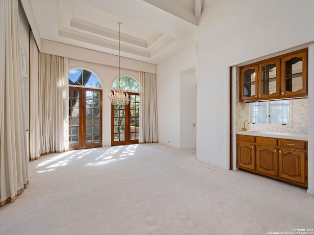 9 Chester Downs, San Antonio, TX 78257 - unfurnished dining area with an inviting chandelier, a sink, and light colored carpet