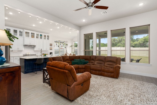 living area featuring light wood-style floors, ceiling fan, recessed lighting, and visible vents