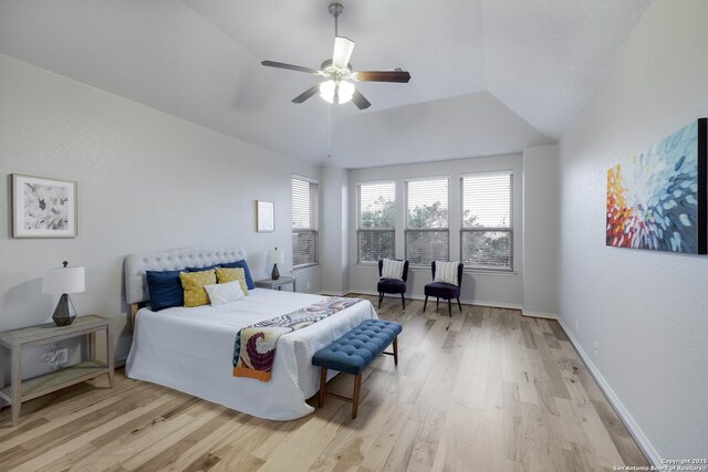 bedroom featuring baseboards, a ceiling fan, and light wood-style flooring