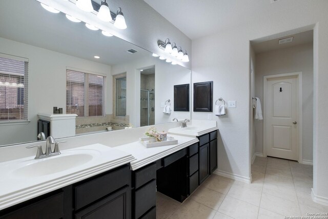 full bath featuring tile patterned floors, visible vents, a sink, and a stall shower