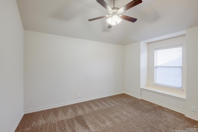 carpeted empty room featuring baseboards and a ceiling fan