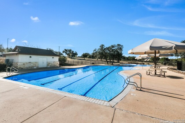 pool featuring a patio area and fence