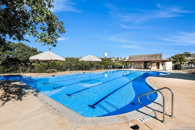 pool featuring a patio and fence