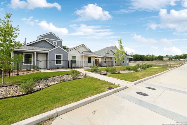 view of front of property with a fenced front yard and a front lawn