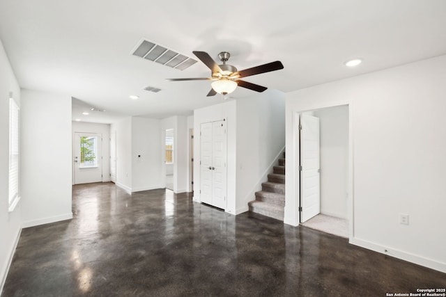 2910 Martin Luther King, San Antonio, TX 78220 - unfurnished living room with finished concrete floors, a ceiling fan, stairs, and baseboards