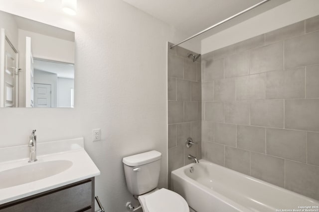 bathroom with toilet, washtub / shower combination, and vanity