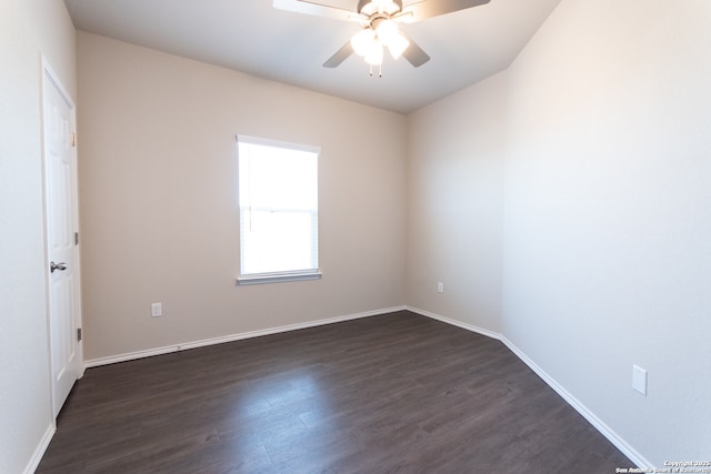 empty room featuring dark wood-type flooring, baseboards, and ceiling fan
