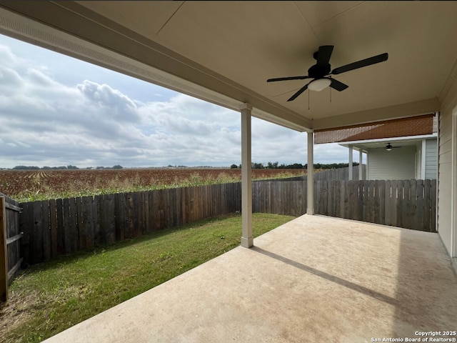 view of patio with a fenced backyard and ceiling fan
