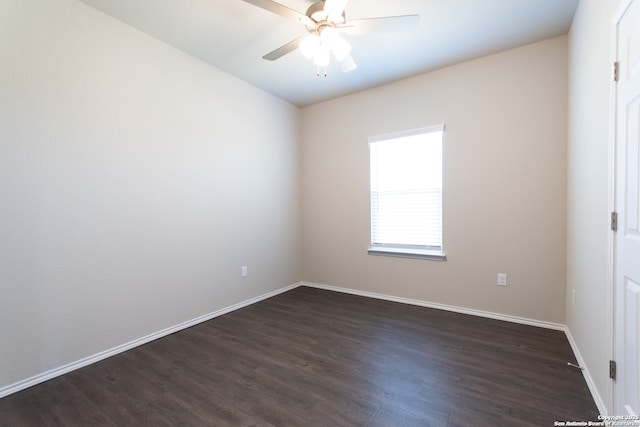 unfurnished room featuring baseboards, ceiling fan, and dark wood-type flooring