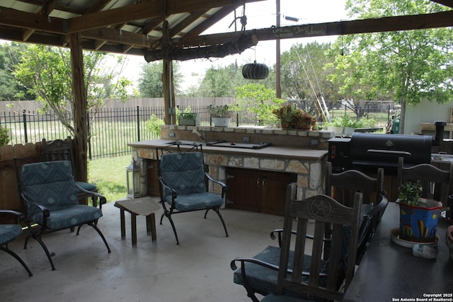 view of patio with a gazebo, fence, and area for grilling