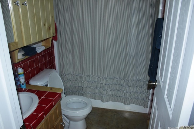 230 N Wph Holmes, Leakey, TX 78873 - bathroom with vanity, toilet, and tile walls