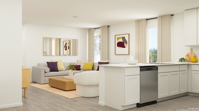 kitchen featuring a peninsula, stainless steel dishwasher, light wood-type flooring, and a sink
