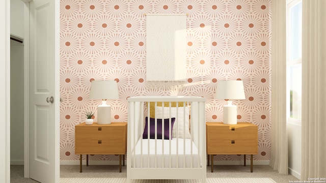bedroom with baseboards, carpet, and a crib