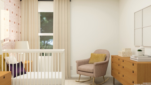 carpeted bedroom featuring a crib and baseboards