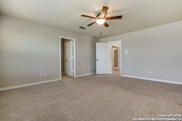 interior space featuring ceiling fan, light colored carpet, baseboards, and visible vents