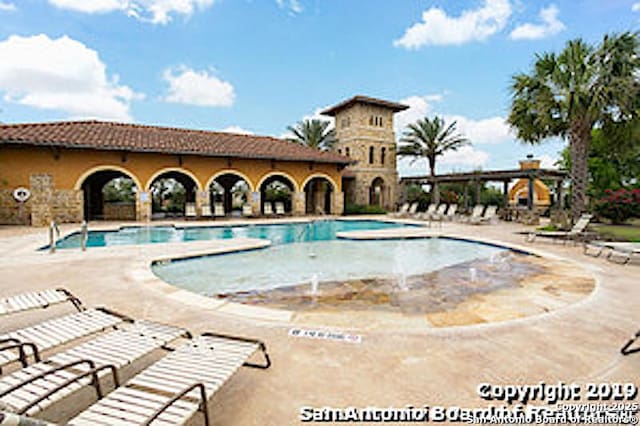 community pool with a patio area