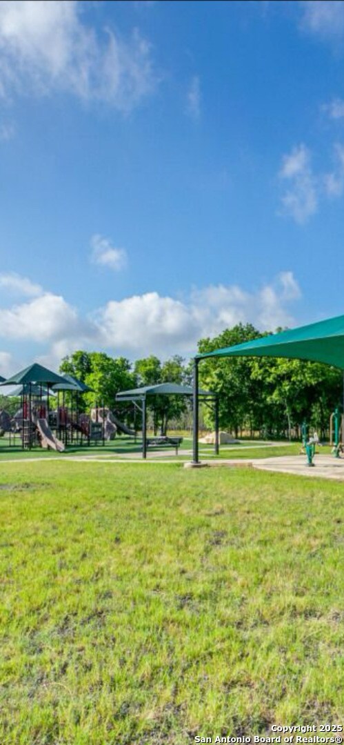 view of home's community featuring a yard and playground community