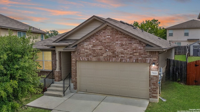 7111 Phoebe Vw, San Antonio, TX 78252 - ranch-style home featuring fence, driveway, brick siding, an attached garage, and a yard