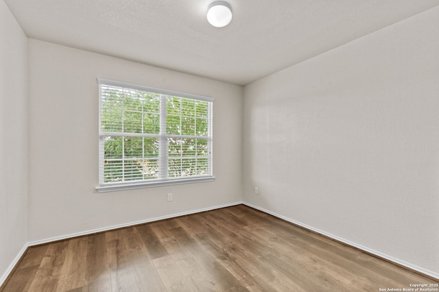 7111 Phoebe Vw, San Antonio, TX 78252 - spare room featuring baseboards and wood finished floors