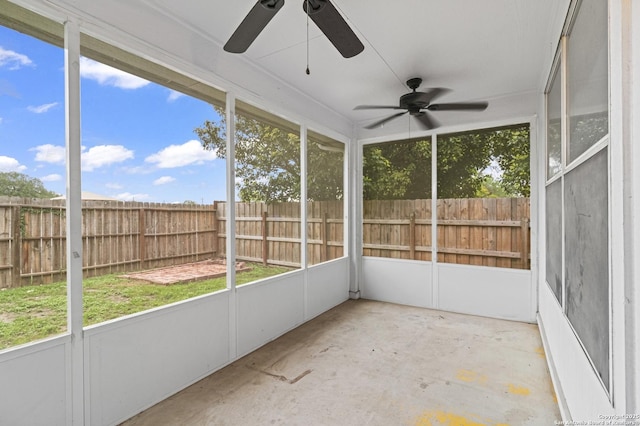 unfurnished sunroom featuring a ceiling fan
