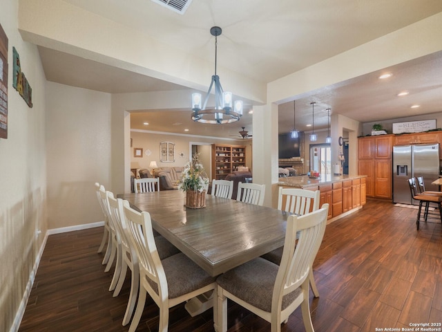 dining area with baseboards, recessed lighting, dark wood-style flooring, and a notable chandelier