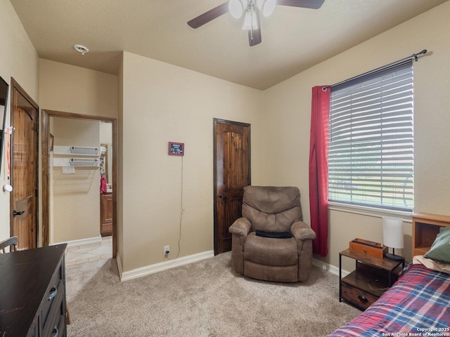 bedroom featuring baseboards, light carpet, and ceiling fan