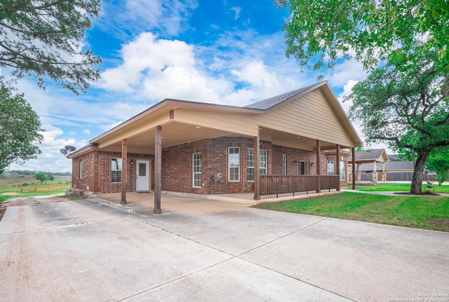 view of home's exterior featuring an attached carport, a yard, driveway, and brick siding