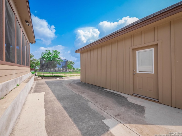 exterior space featuring board and batten siding and a patio area