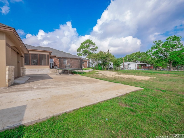 view of yard with a sunroom, a patio area, and fence