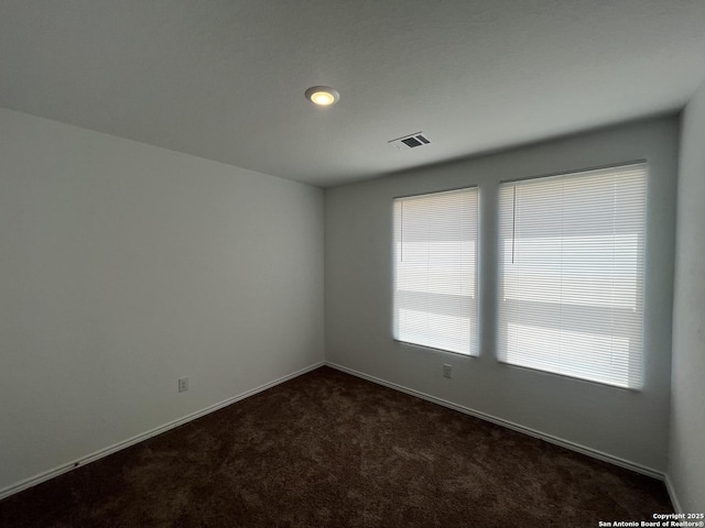 8823 Astral Pl, San Antonio, TX 78252 - empty room with baseboards, dark colored carpet, and visible vents