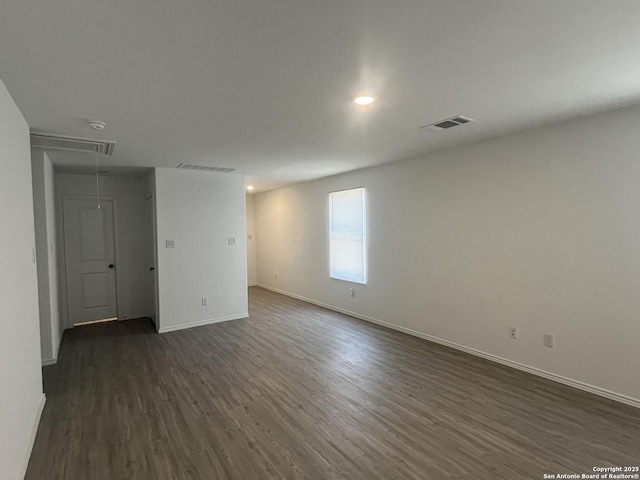 8823 Astral Pl, San Antonio, TX 78252 - unfurnished room featuring baseboards, visible vents, dark wood finished floors, and attic access