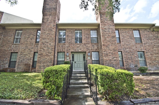 201 Ellwood Unit 107, San Antonio, TX 78209 - view of front of house featuring a chimney and brick siding