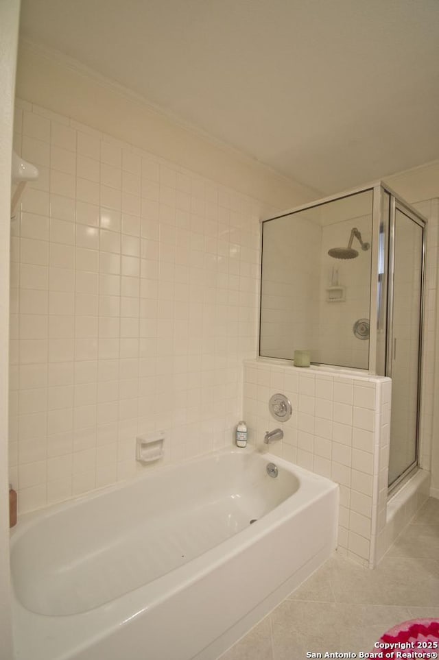 full bathroom with tile patterned flooring, a bath, a stall shower, and ornamental molding