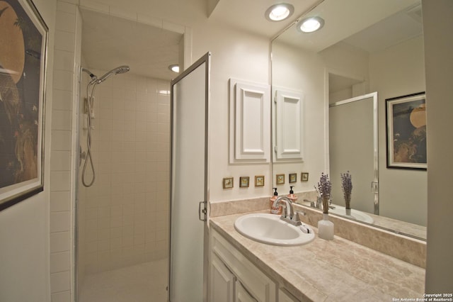 bathroom featuring a shower stall and vanity