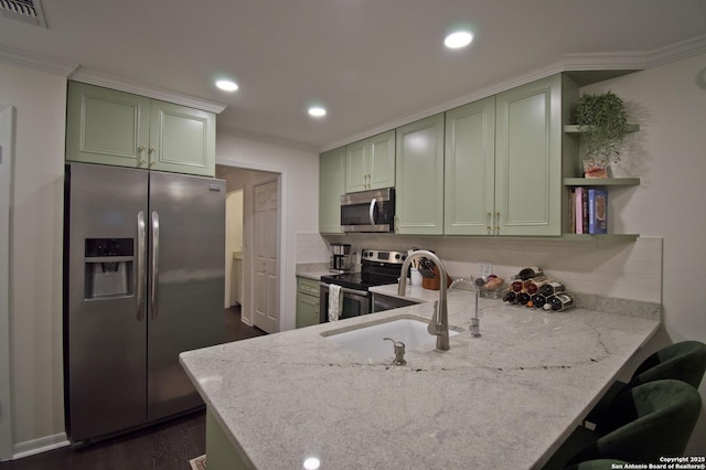 kitchen with visible vents, a sink, appliances with stainless steel finishes, and green cabinets