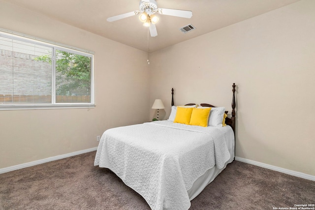 carpeted bedroom with baseboards, visible vents, and ceiling fan