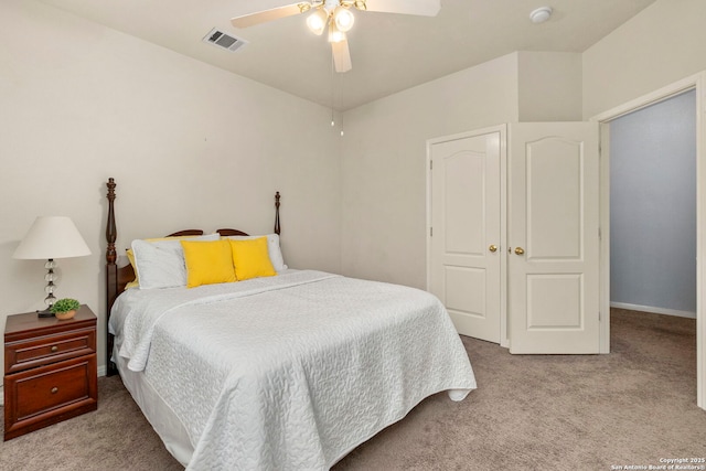 carpeted bedroom with visible vents and ceiling fan