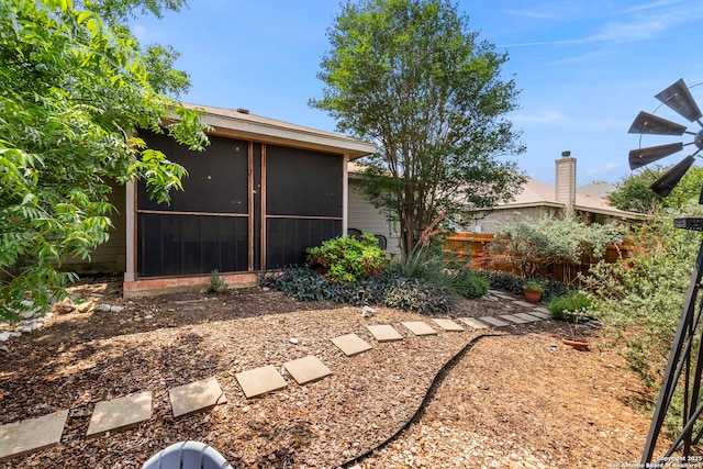 view of yard with a sunroom and fence