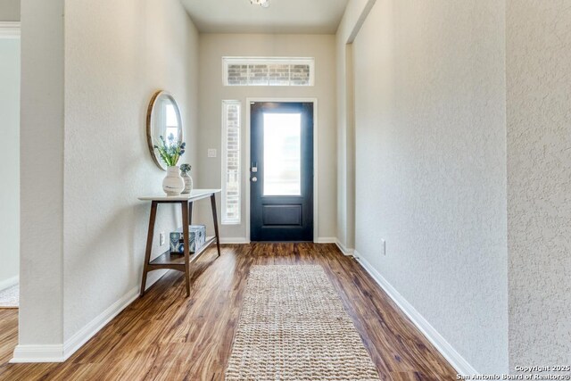 11922 Tower Crk, San Antonio, TX 78253 - entrance foyer with baseboards, a textured wall, and wood finished floors