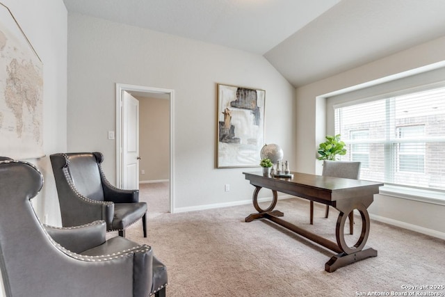office featuring baseboards, vaulted ceiling, and carpet