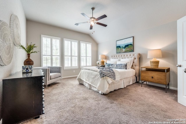 carpeted bedroom featuring baseboards, ceiling fan, and vaulted ceiling
