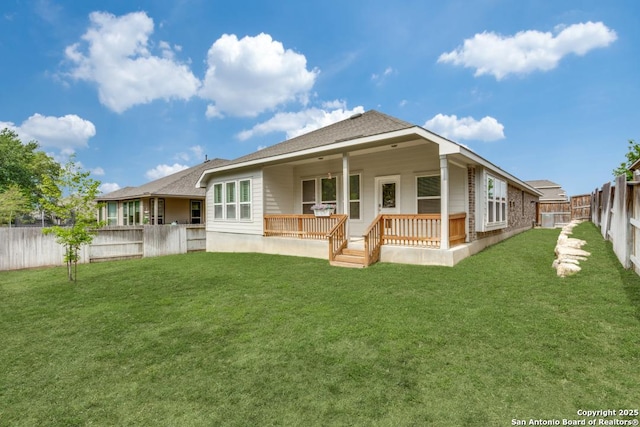 back of property featuring a lawn and a fenced backyard